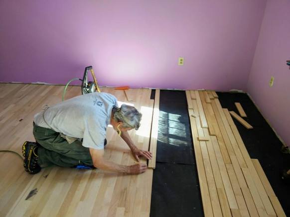 Jim laying strip flooring